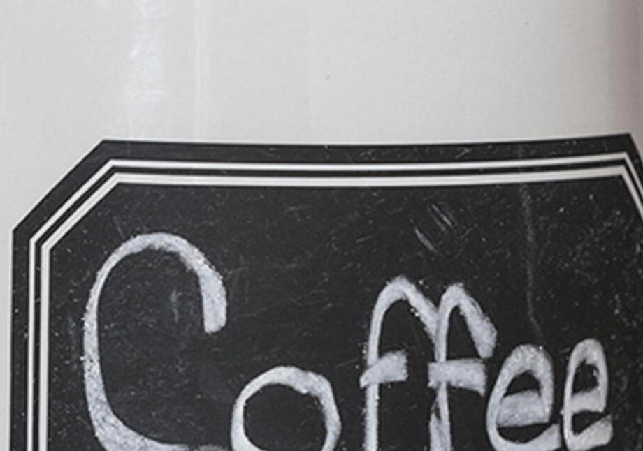 A ceramic container with Coffee written on the side.