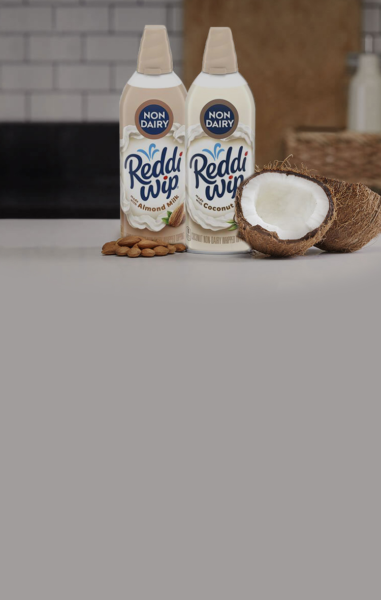 Reddi Wip Non-Dairy cans next to almonds and coconuts
